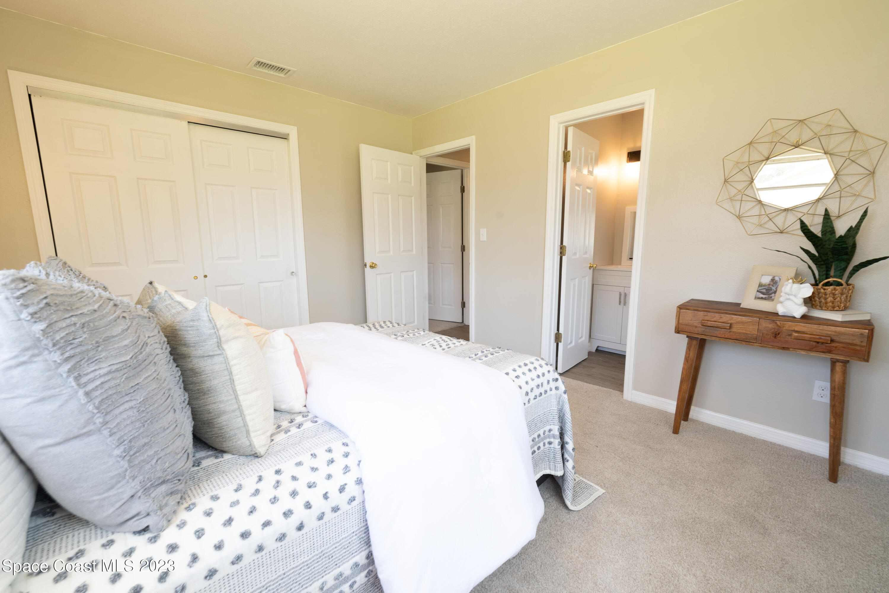 2411 Dairy Road Melbourne, FL 32901 - Photo 12 of 25 a bedroom with a bed and a table