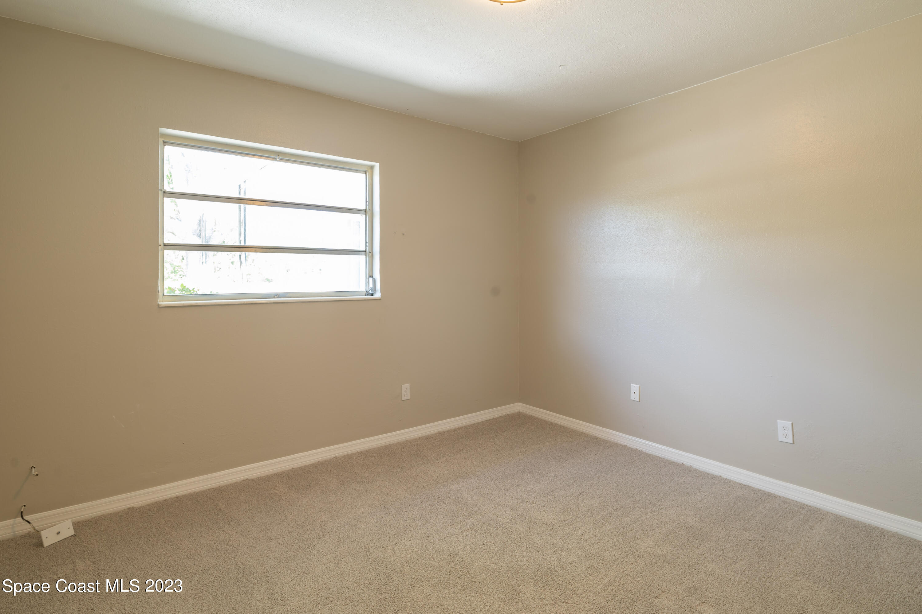 2411 Dairy Road Melbourne, FL 32901 - Photo 14 of 25 an empty room with a window