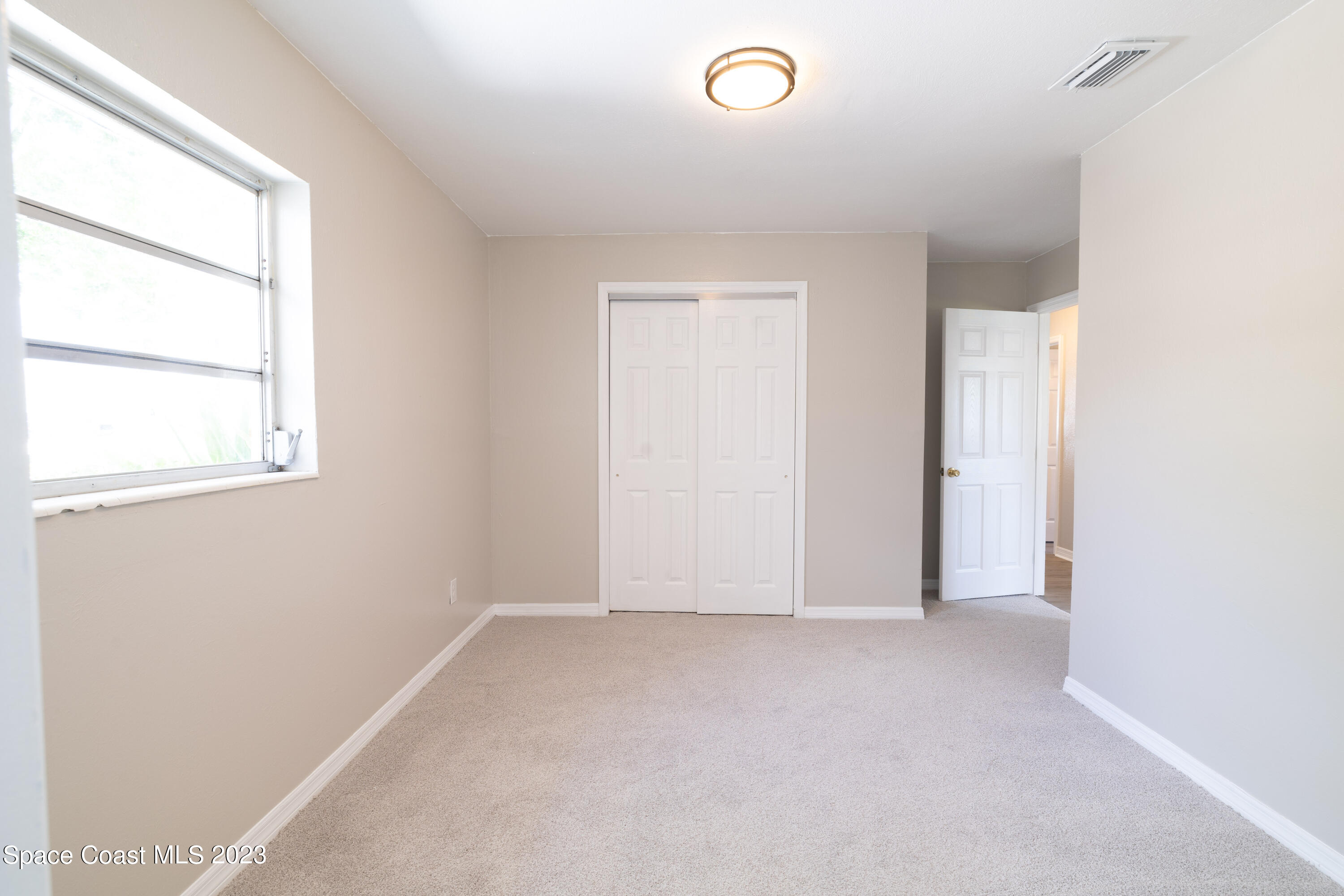 2411 Dairy Road Melbourne, FL 32901 - Photo 16 of 25 an empty room with a empty space and a window
