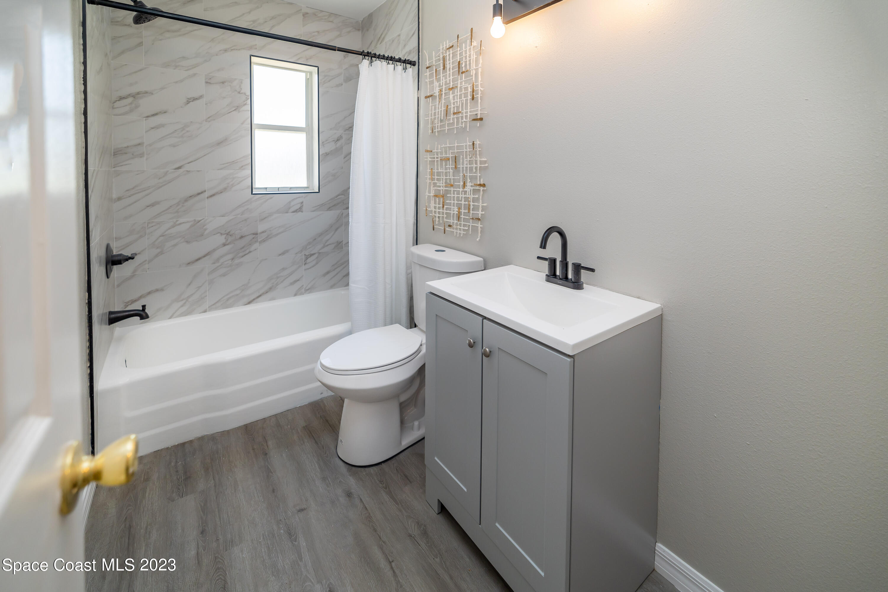 2411 Dairy Road Melbourne, FL 32901 - Photo 17 of 25 a bathroom with a sink toilet and shower