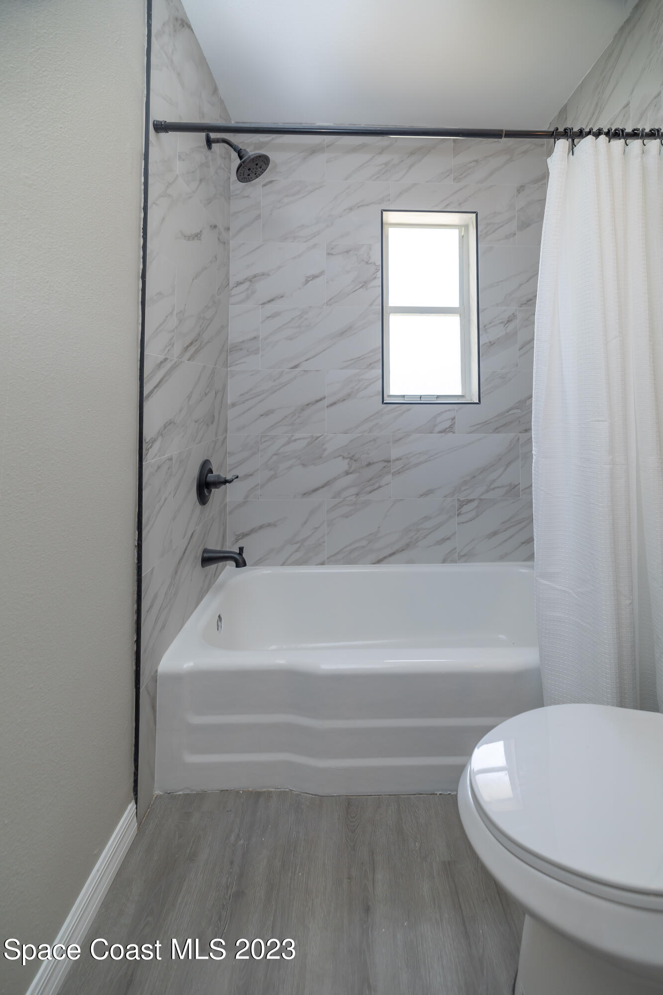 2411 Dairy Road Melbourne, FL 32901 - Photo 18 of 25 a bathroom with a bathtub and a toilet