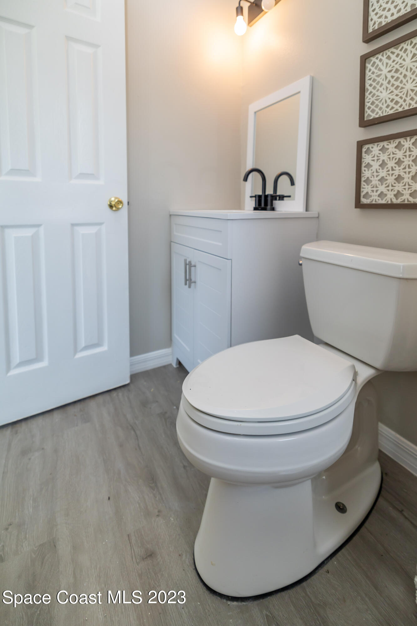 2411 Dairy Road Melbourne, FL 32901 - Photo 19 of 25 a white toilet sitting next to a bathroom sink