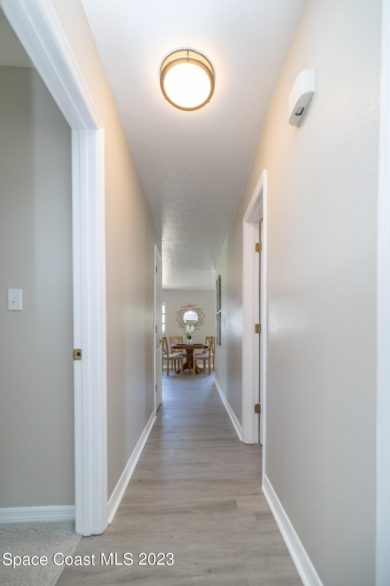 2411 Dairy Road Melbourne, FL 32901 - Photo 20 of 25 a view of a hallway with wooden floor and furniture