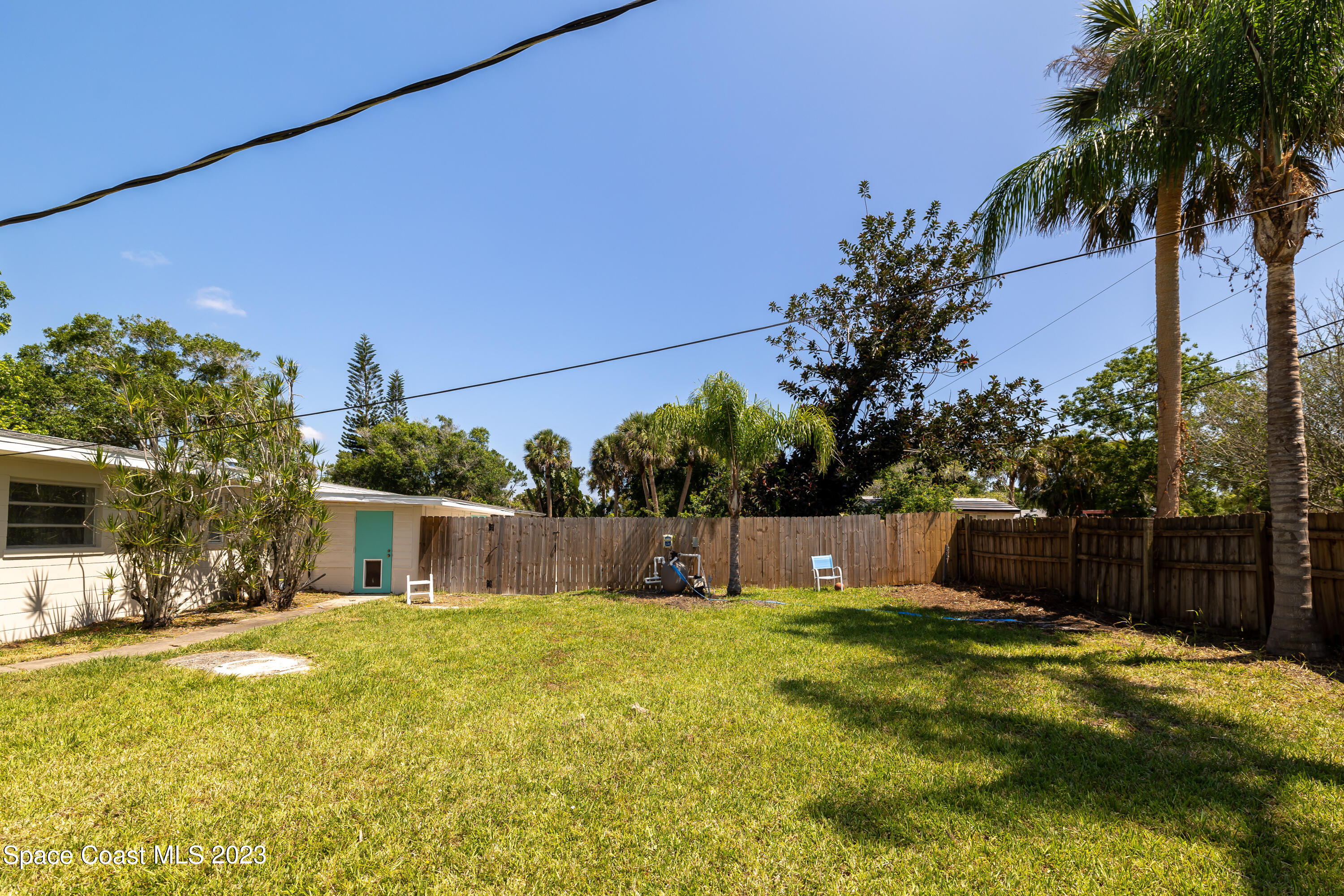 2411 Dairy Road Melbourne, FL 32901 - Photo 24 of 25 a swimming pool with outdoor seating and yard