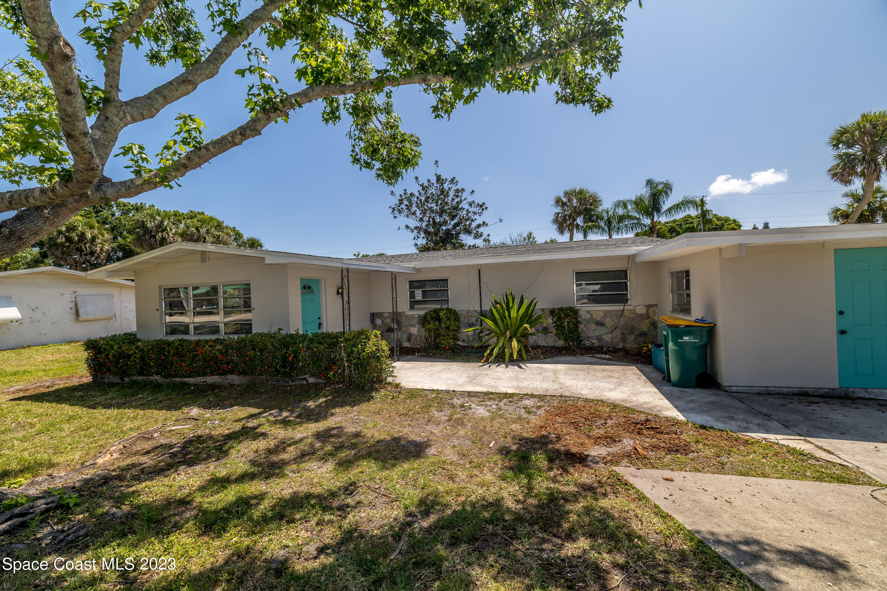 2411 Dairy Road Melbourne, FL 32901 - Photo 3 of 25 a front view of a house with a yard and potted plants
