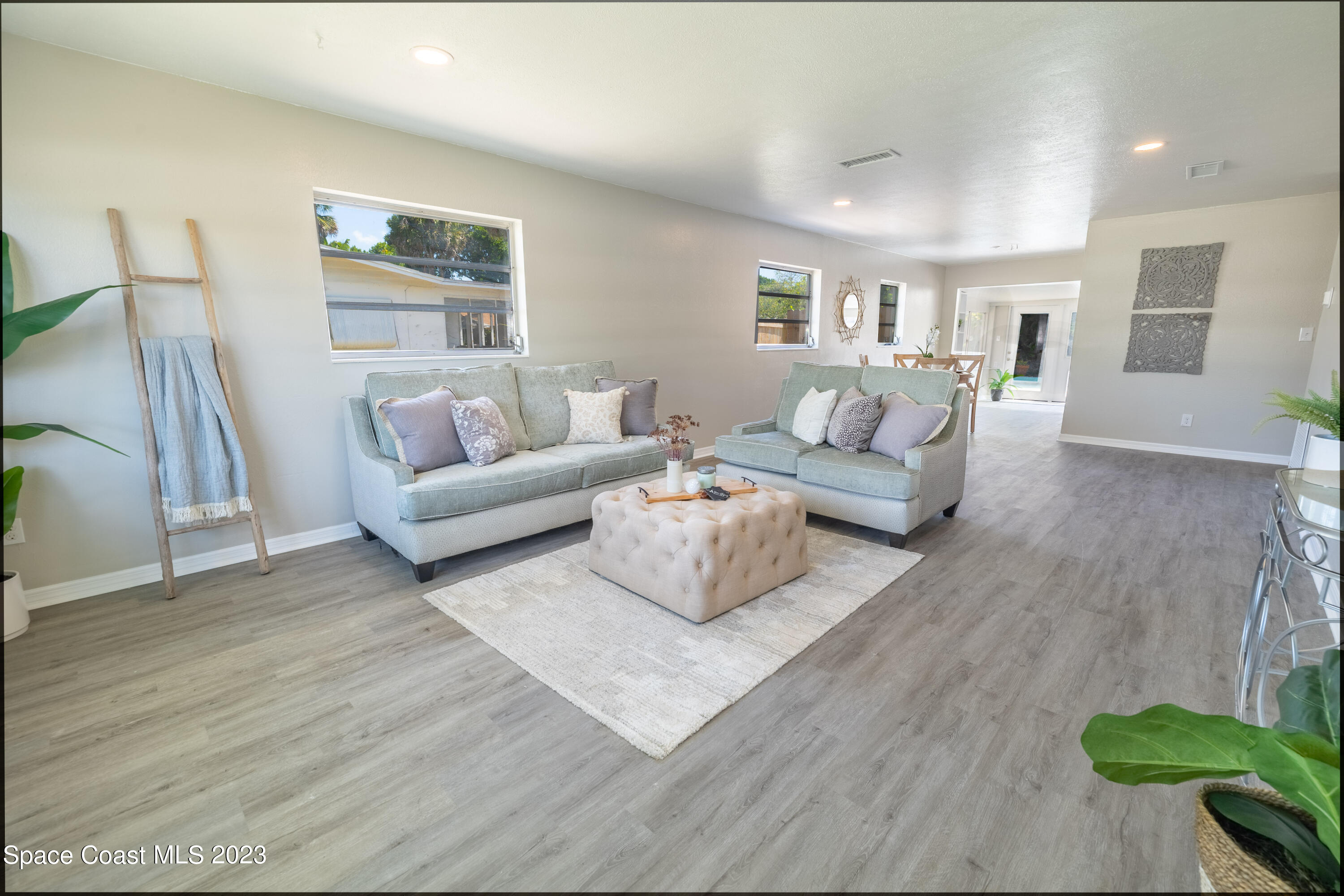 2411 Dairy Road Melbourne, FL 32901 - Photo 5 of 25 a living room with furniture and a wooden floor