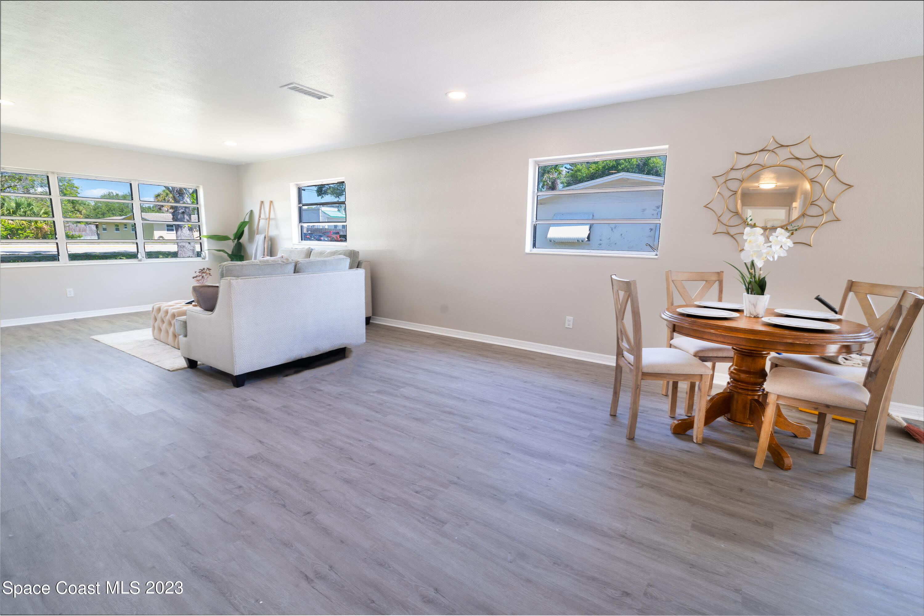 2411 Dairy Road Melbourne, FL 32901 - Photo 6 of 25 a living room with furniture and a wooden floor