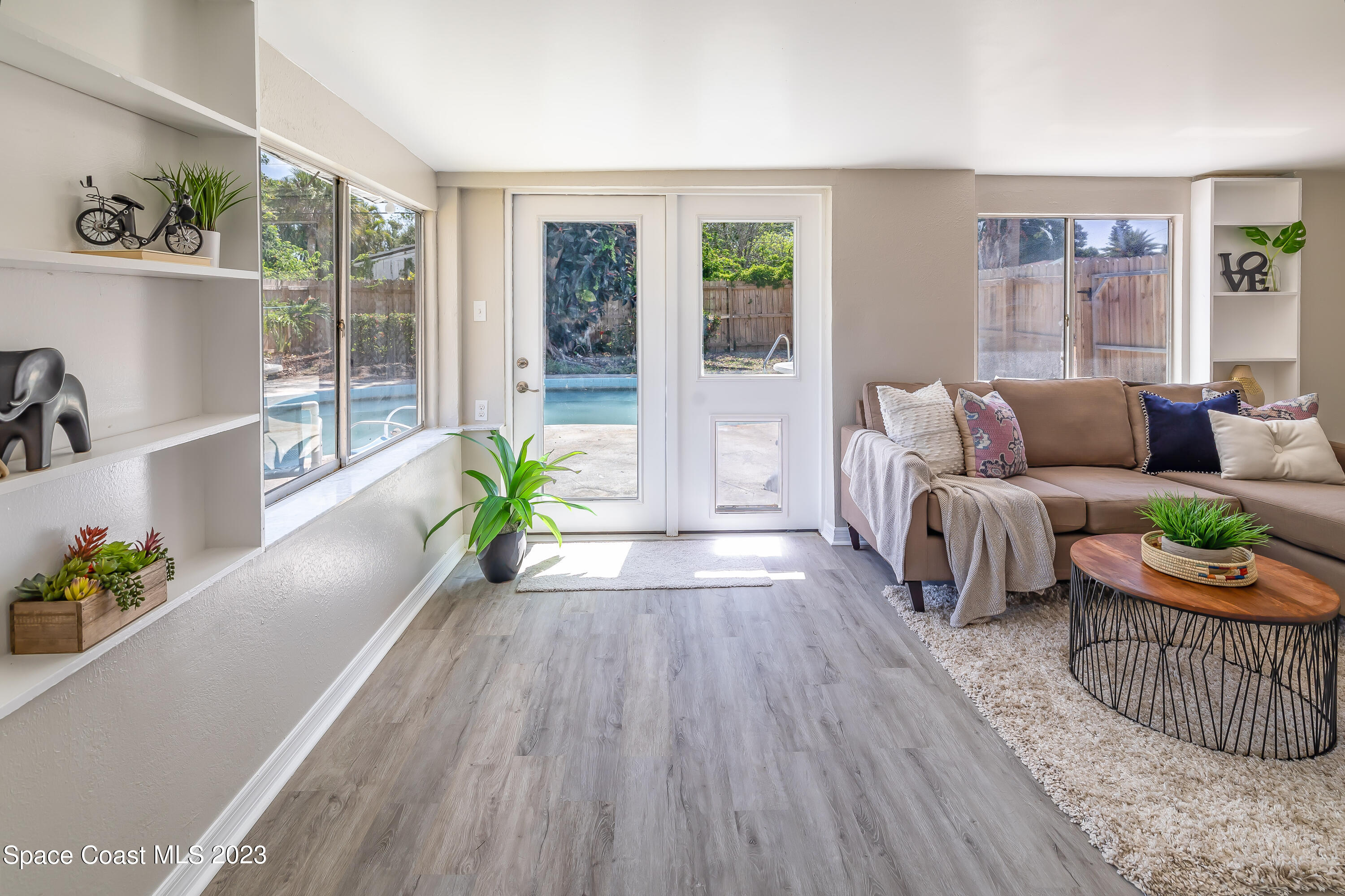 2411 Dairy Road Melbourne, FL 32901 - Photo 8 of 25 a living room with furniture and a wooden floor