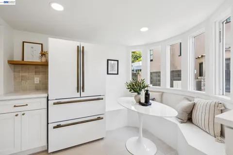 a bedroom with a bed and a dresser next to a window