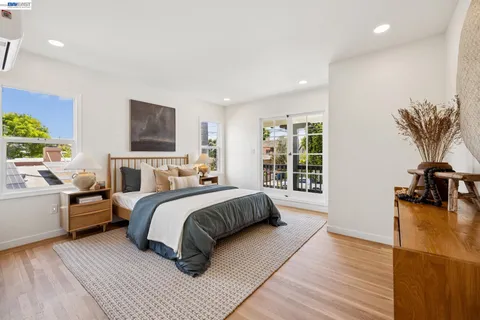 a living room with furniture a wooden floor and a window