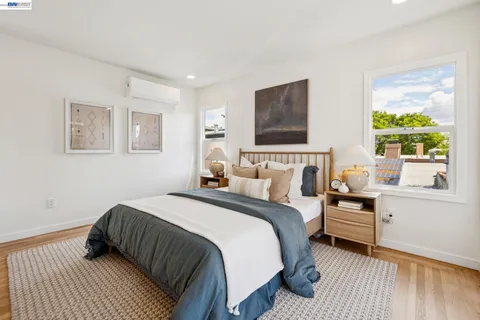 a view of a house with large windows and a wooden fence