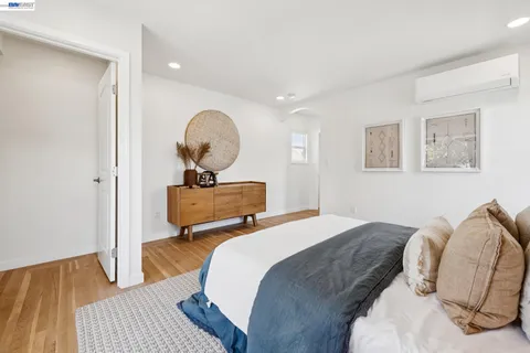 a front view of multi story residential apartment building with yard and green space