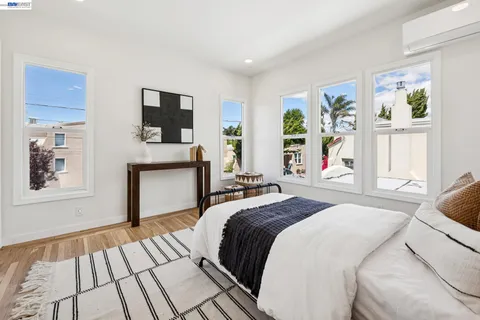 a bedroom with a bed and a chair with the potted plant