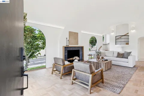a living room with furniture a fireplace and a table
