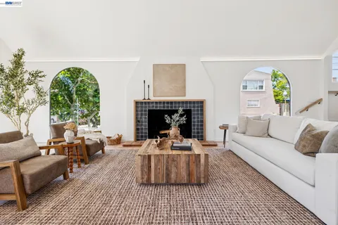 a dining hall with stainless steel appliances a dining table and chairs with kitchen island