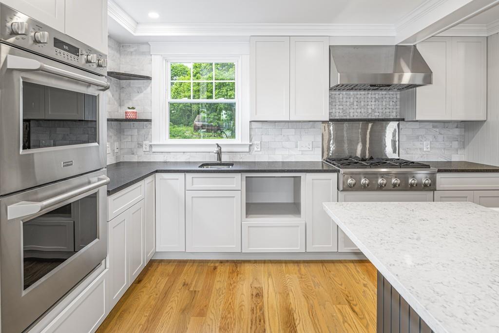 52 Elmore Road Hingham, MA 02043 - Photo 20 of 39 a kitchen with a sink stove and microwave