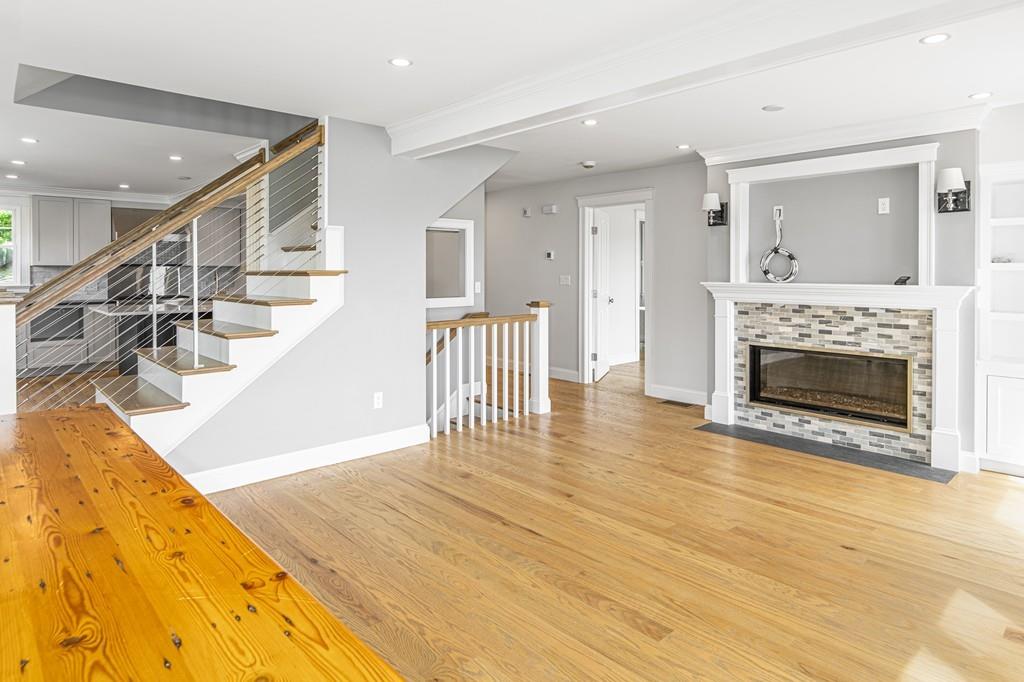 52 Elmore Road Hingham, MA 02043 - Photo 26 of 39 a view of a livingroom with wooden floor and a fireplace