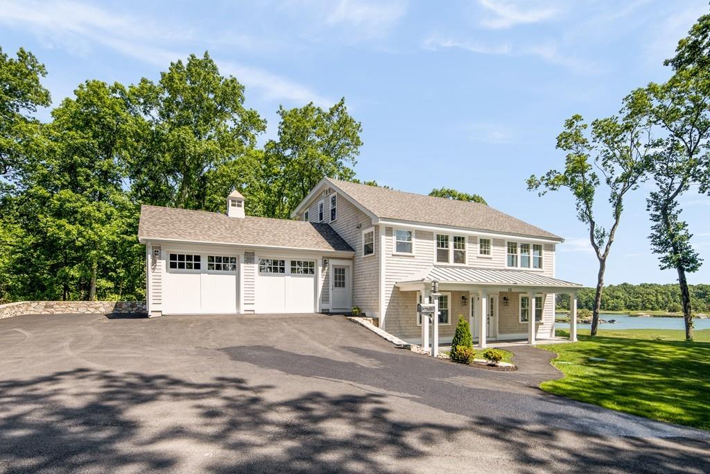 52 Elmore Road Hingham, MA 02043 - Photo 3 of 39 a front view of a house with a garden