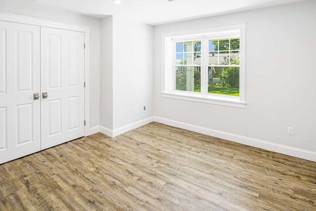 52 Elmore Road Hingham, MA 02043 - Photo 32 of 39 an empty room with wooden floor and windows