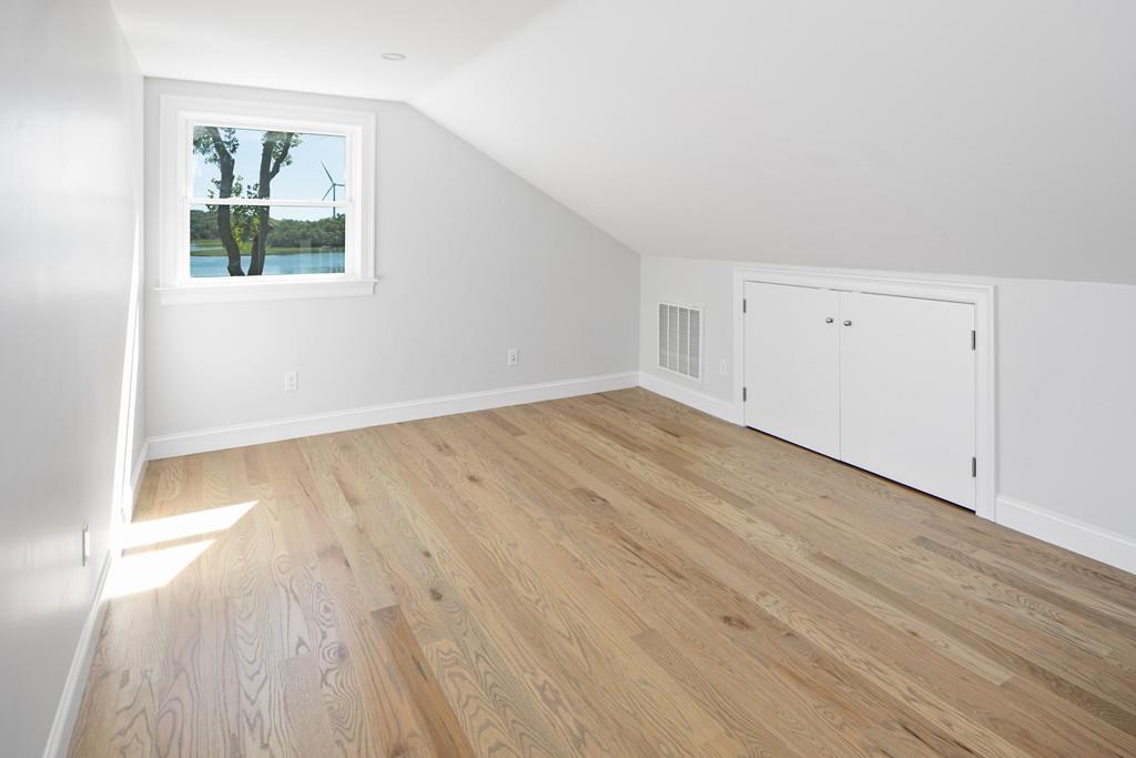 52 Elmore Road Hingham, MA 02043 - Photo 35 of 39 an empty room with wooden floor and windows