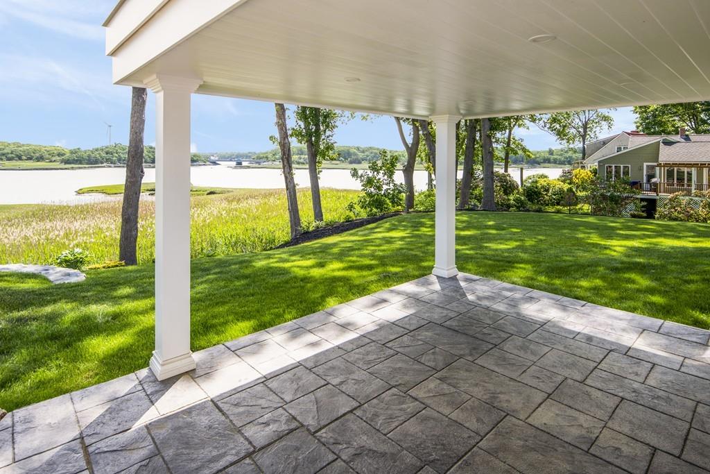 52 Elmore Road Hingham, MA 02043 - Photo 10 of 39 a view of a porch with a big yard potted plants and large tree