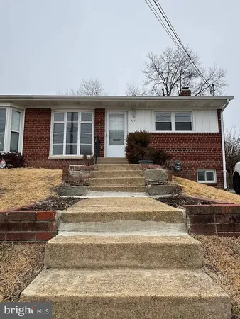a view of a house with a large window and couches
