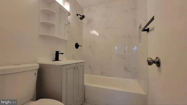 a bathroom with a bathtub a toilet and a shower