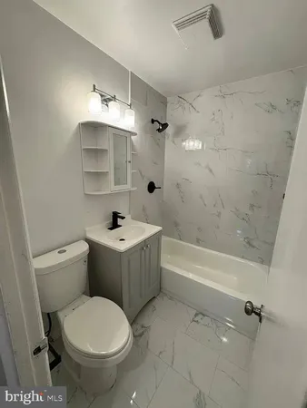 a bathroom with a sink toilet a shower and bathtub