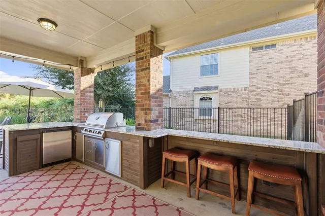 a kitchen with stainless steel appliances granite countertop a sink and cabinets
