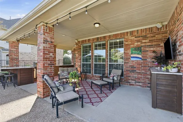 a view of a patio with a table and chairs
