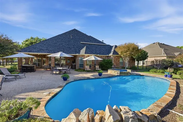 a view of a house with swimming pool and sitting area