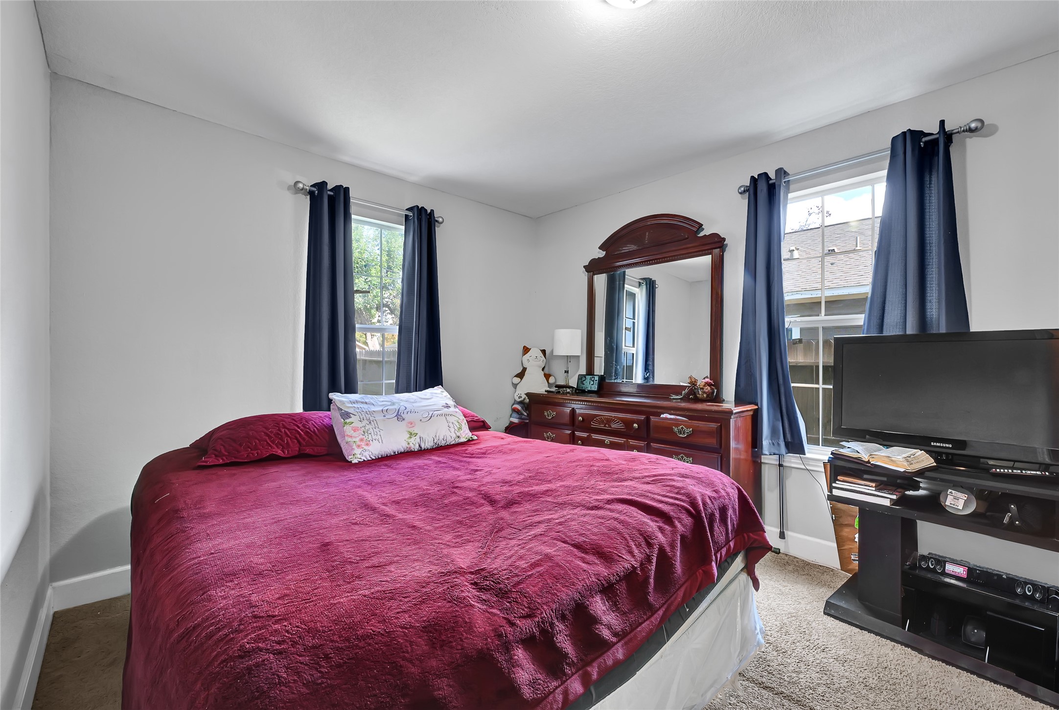 6227 Cavalier Street, Unit 770 Houston, TX 77087 - Photo 13 of 19 a bedroom with a bed and a flat screen tv