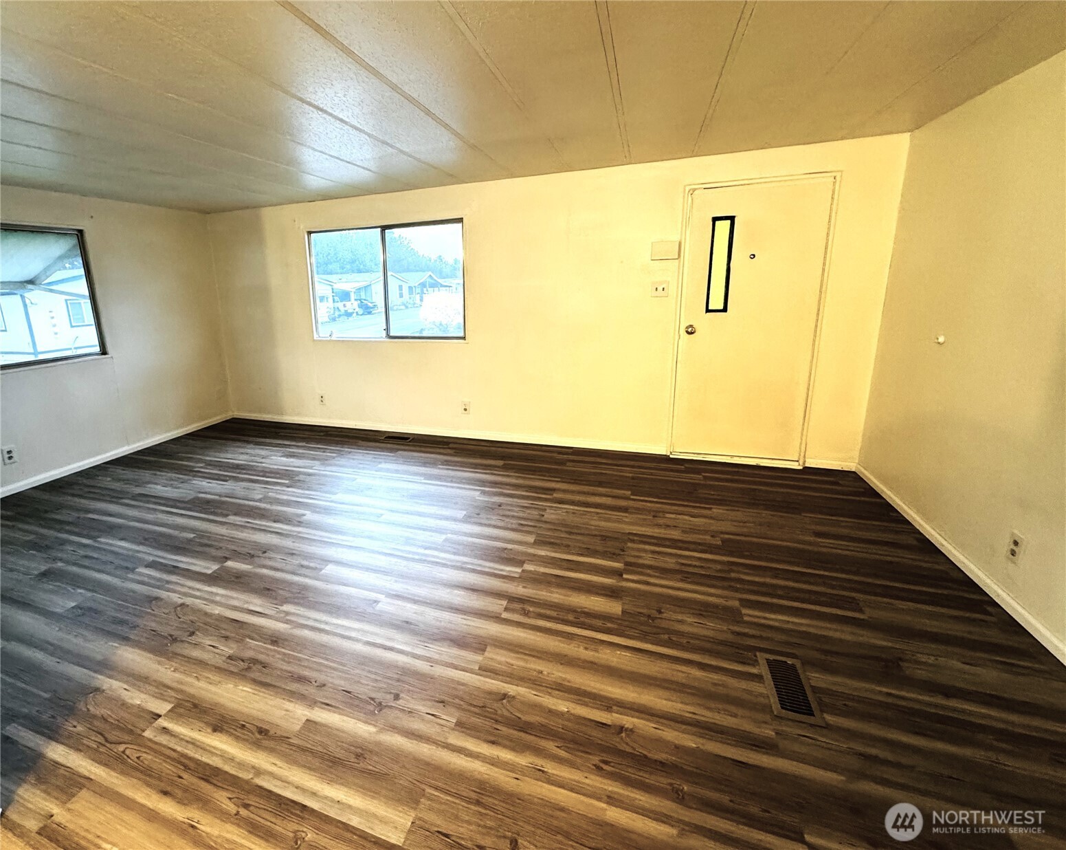 63 Onyx Street Walla Walla, WA 99362 - Photo 6 of 16 a view of an empty room with wooden floor and a window