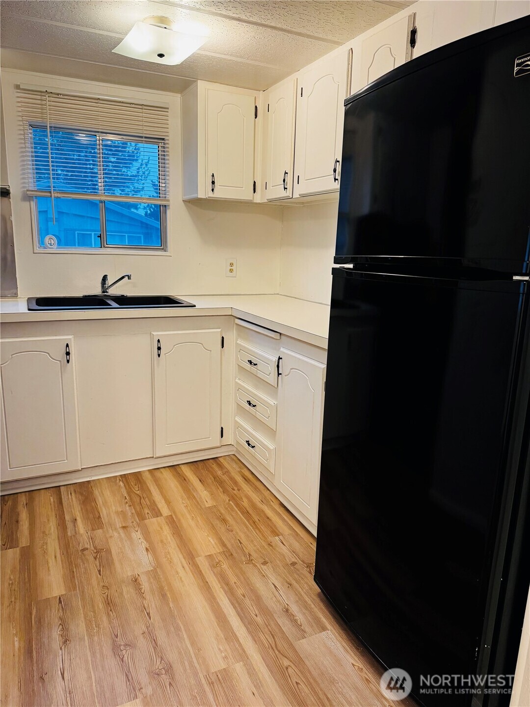 63 Onyx Street Walla Walla, WA 99362 - Photo 9 of 16 a kitchen with a refrigerator and window