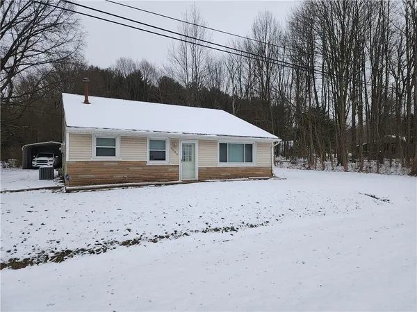 a view of a house with a snow in the yard
