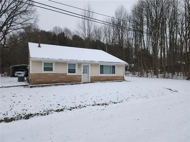 a view of a house with a snow in the yard