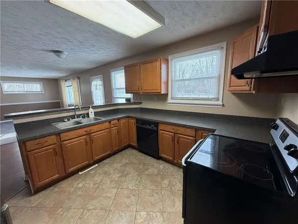 a kitchen with a sink stove and cabinets