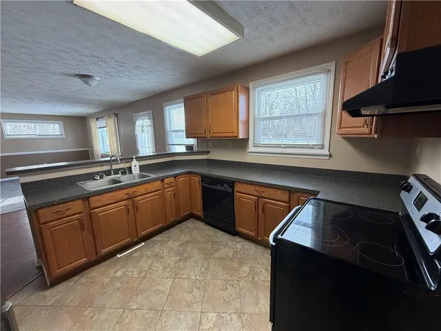 a kitchen with a sink stove and cabinets