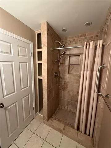 a bathroom with a shower and a tub