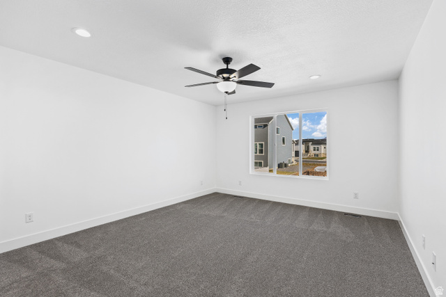 1139 South 4475 West West Point, UT 84015 - Photo 16 of 33 Unfurnished room with dark colored carpet, a ceiling fan, and recessed lighting