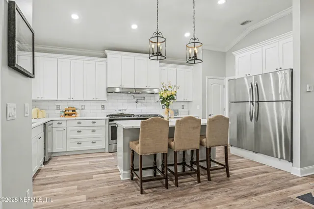 a view of living room with furniture and wooden floor