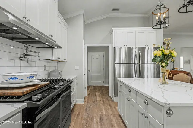 a en suite bathroom with a granite countertop sink and a window