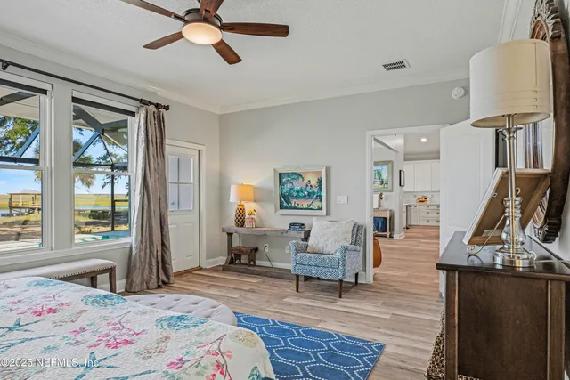 a bedroom with a bed and painting on the wall