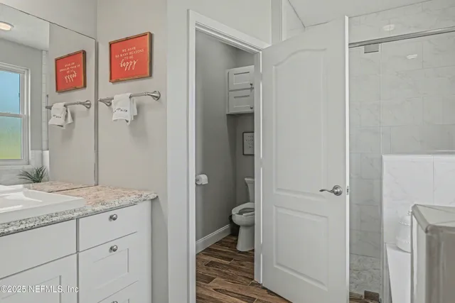 a white toilet sitting next to a bathroom sink