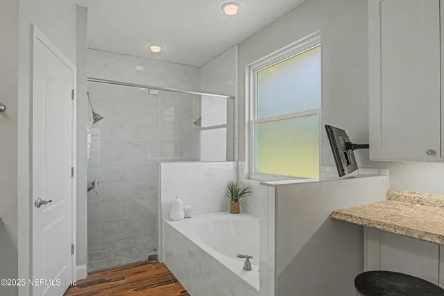 a bathroom with a painting on the wall and a toilet