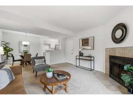 a living room with furniture a clock and a fireplace