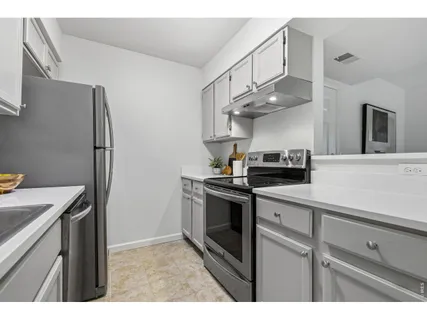 a kitchen with stainless steel appliances granite countertop a sink and a stove