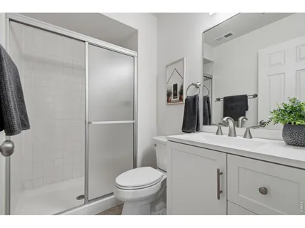 a bathroom with a toilet a sink and shower
