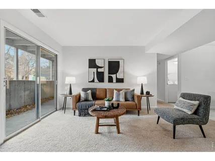 a living room with furniture and a lamp