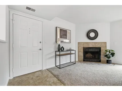 a view of a livingroom with furniture and a fireplace
